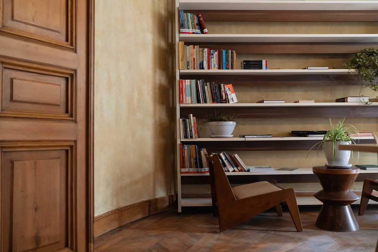 Inviting reading corner with wooden shelves and comfortable seating
