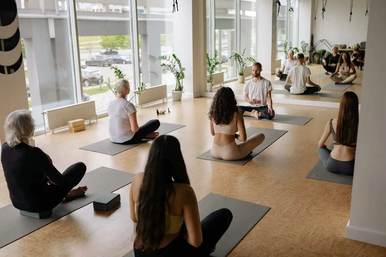 Group yoga session in sunlit studio