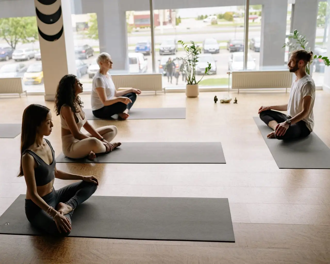 Group of people practicing mindfulness in a bright studio
